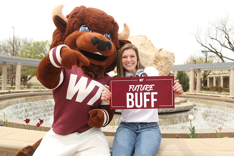 female student with Bucky and sign saying future buff