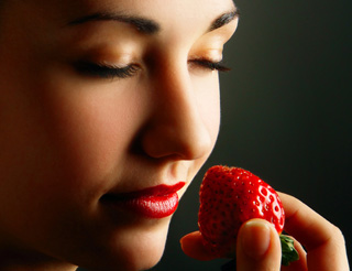 woman smelling strawberry